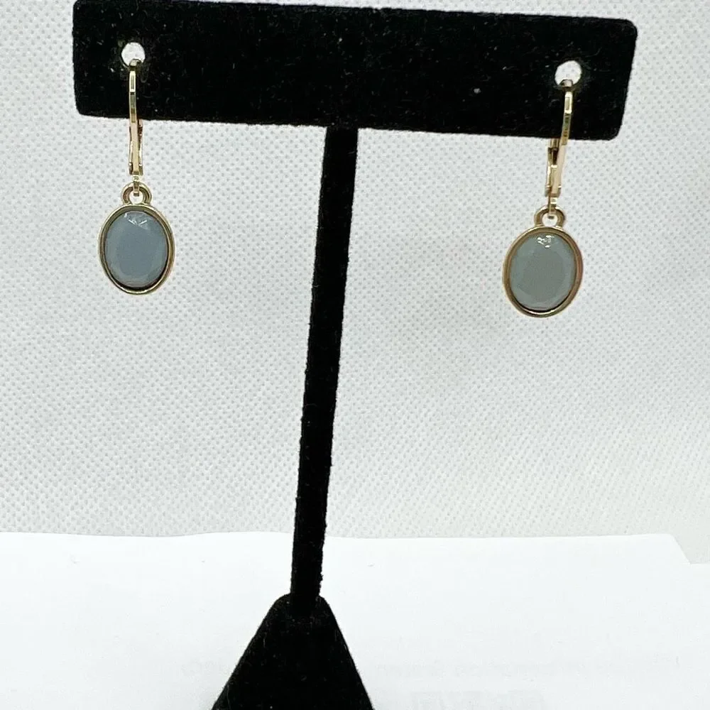 Faceted blue grey hinge dangle earrings on gold tone backing
